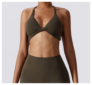 Front view of olive green yoga set with halter bra, knot detail and high-waist leggings