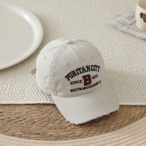 Close-up of distressed brim detail and letter B embroidery on kids' baseball cap