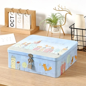 Vintage blue tin storage box with lock and cartoon fox illustration on wooden table