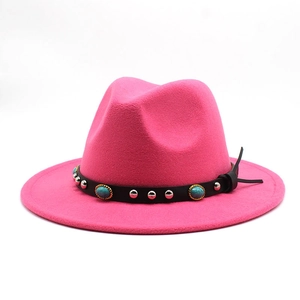 Close-up of rose pink felt hat with turquoise and silver studded black leather band
