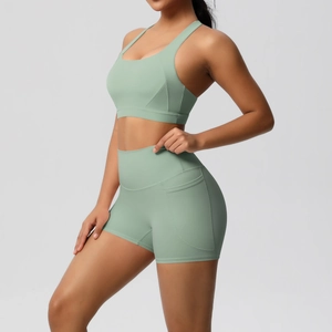 Detailed side view of high-waisted yoga shorts with functional side pocket in sage green
