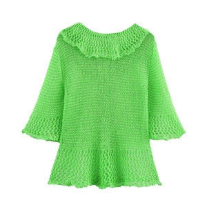 Detail view of grass green crochet knit top with mesh texture and ruffled collar