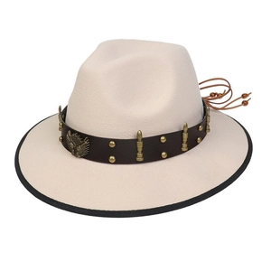 Detail of cream western cowboy hat with brown leather band and metal eagle emblem