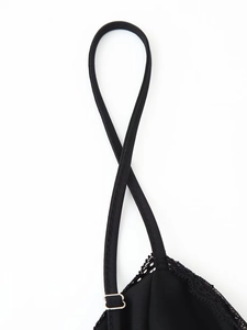 Detail of adjustable black elastic strap and delicate lace stitching on bodycon dress