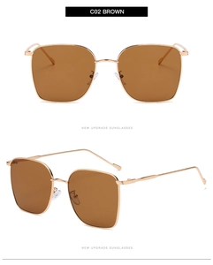 Detail view of square metal oversized sunglasses with brown lenses and golden frame