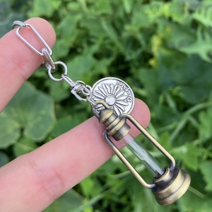 Macro detail of bronze kerosene lamp necklace with You are my sunshine engraving