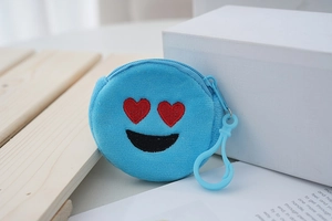 Detailed view of mini blue plush coin purse with embroidered heart eyes emoji face