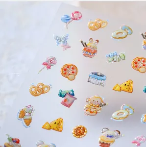 Macro detail of cute cartoon dessert and food patterns on transparent nail art stickers