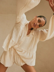 Detailed texture of beige cotton linen long sleeve shirt and drawstring shorts set