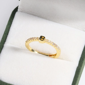Close-up of 18k gold plated adjustable ring with letter B and sparkling crystal inlay