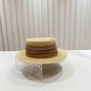 French flat top straw boater hat with a wide brown ribbon for sun protection at the beach