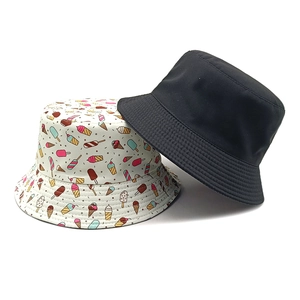 Set of two bucket hats in solid black and colorful ice cream print patterns