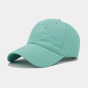 Detailed view of the sun embroidery and curved brim on this mint green baseball cap