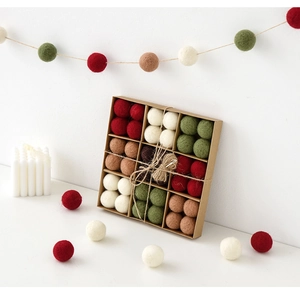 Detail of wool felt balls in a kraft gift box with hemp rope for Christmas decor
