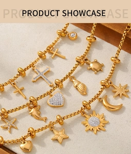 Detail of 18k gold plated box chains featuring zircon charms like cross, heart and sun