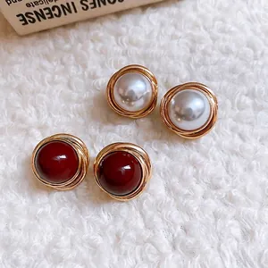 Elegant retro stud earring set featuring white pearls and red beads in gold wire spirals