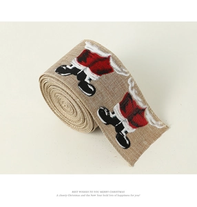 Close-up of faux linen Christmas ribbon with Santa Claus print for gift wrapping