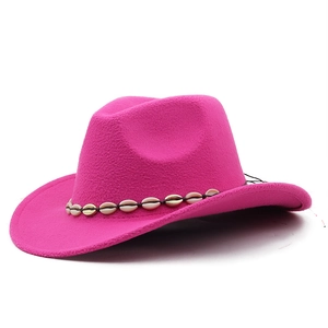 Detail of rose red felt cowboy hat featuring a white and gold shell decorative band