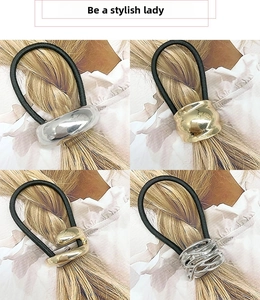 Detail of geometric metal hair ties with various textures on a minimalist ponytail