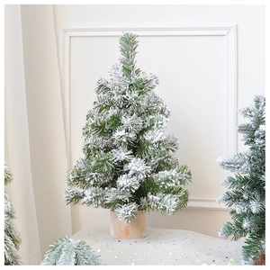 Detailed view of mini snow-flocked Christmas tree with natural cedar base