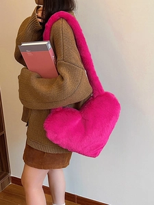 Furry heart-shaped shoulder bag in bright pink faux fur with plush cloud texture