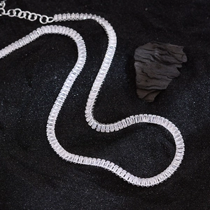 Silver tennis necklace with rectangular zircon stones on professional black background