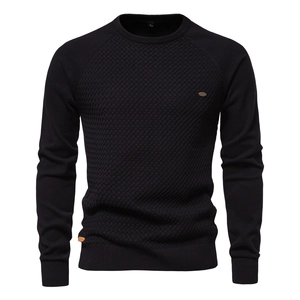 Detailed macro shot of men's black knit sweater featuring 3D diamond texture and crew neck