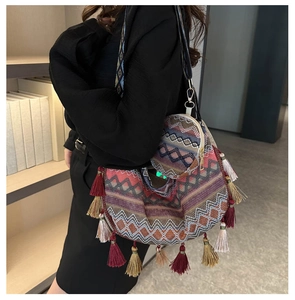 Detail of ethnic woven tote bag with colorful tassels and a matching coin purse