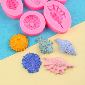 Pink silicone molds for seashell and sea urchin shaped fondant with colorful finished crafts
