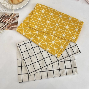 Linen placemats with geometric grid patterns in yellow and white for home dining decor