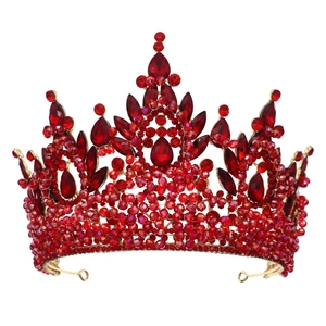 Luxury gold bridal crown with sparkling red crystals on a clean white background