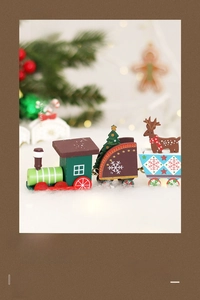 Macro detail of painted wooden Christmas train with reindeer and tree ornaments