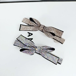 Detail of crystal rhinestone bow hair clips in silver and iridescent finishes