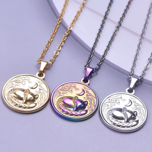 Macro detail of round fox and moon embossed pendants in gold, silver, and rainbow steel