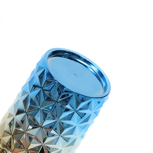 Close-up of blue-gold gradient studded texture and circular lid of a plastic tumbler cup