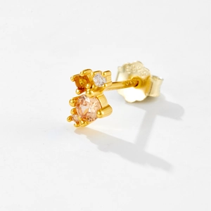 Macro shot of S925 sterling silver gold earrings with sparkling champagne zircon stones