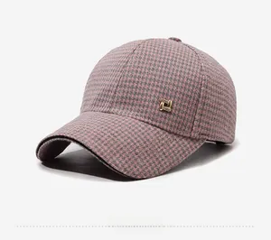 Detail of pink and grey houndstooth wool baseball cap with gold rhinestone side buckle