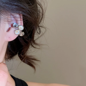 Close-up of zircon curved ear cuff showing four brilliant stones on silver alloy