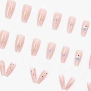 Pink press-on nails with strawberry cake designs and glitter in a ballerina shape