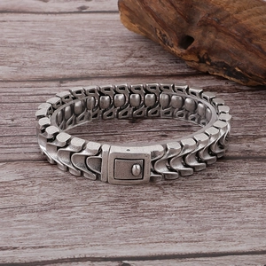 Macro detail of men's vintage dragon bone chain bracelet with antique silver finish
