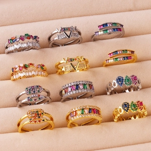 Macro detail of geometric zircon rings in gold and silver set in a velvet jewelry box