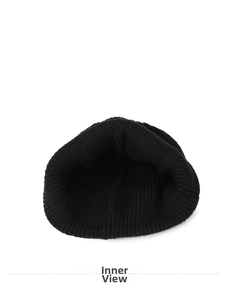 Interior view showing the thick ribbed knit lining of a black winter beanie hat