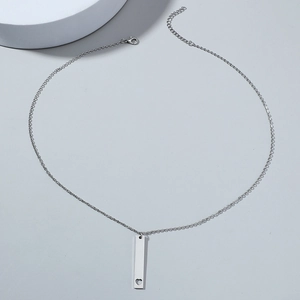 Polished stainless steel bar necklace featuring a heart cutout on a minimalist silver chain
