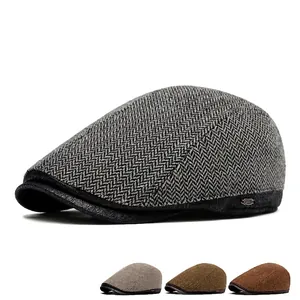 British style herringbone tweed newsboy cap for men featuring adjustable back and metal logo