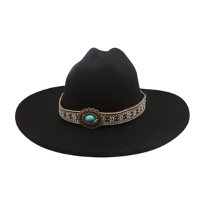 Detail of black felt cowboy hat with vintage turquoise belt and ethnic patterns