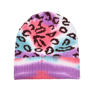 Detail of tie-dye knit beanie featuring black leopard print and thick folded cuff design