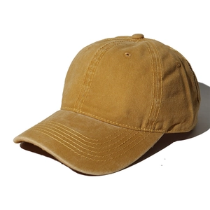 Classic mustard yellow washed cotton baseball cap with vintage distressed texture