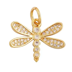 Detail view of gold dragonfly pendant with white zircon inlay and 17x14mm dimensions