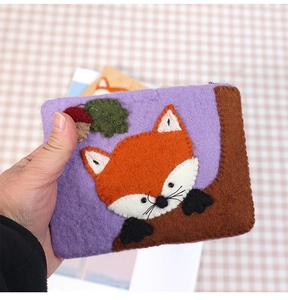 Detail of wool felt coin purse with cute handmade fox and forest embroidery