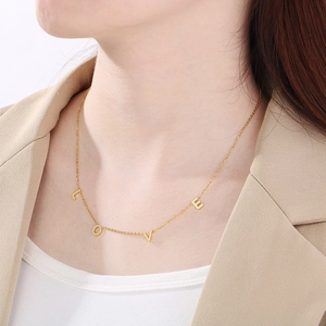 Elegant 18K gold-plated LOVE letter pendant necklace shown on a female model neck